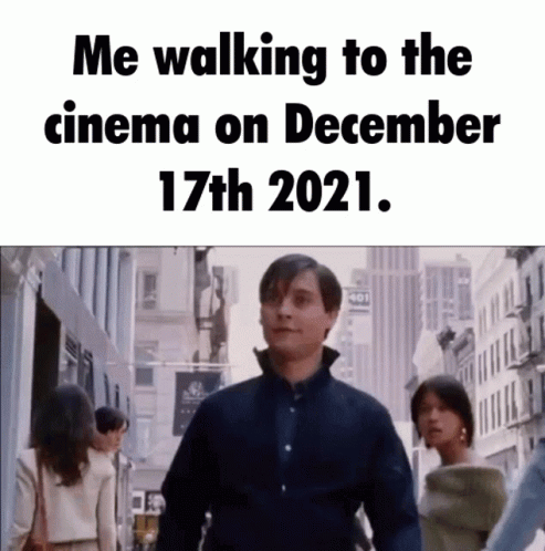 A Man Is Walking Down A City Street With A Caption That Says Me Walking To The Cinema On December 17Th 2021 GIF