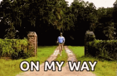 A Man Is Walking Down A Dirt Road With The Words On My Way Above Him GIF