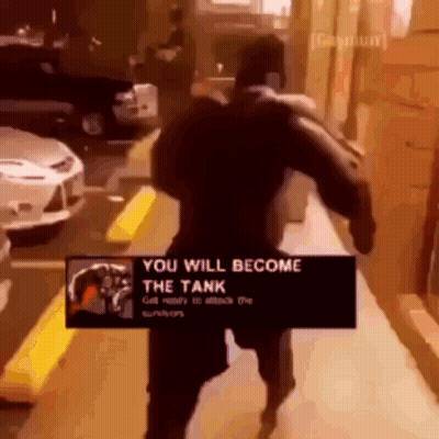 A Man Is Walking Down A Sidewalk With A Sign That Says You Will Become The Tank GIF