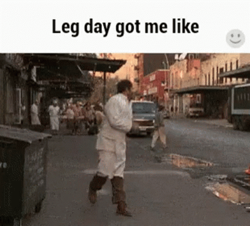 A Man Is Walking Down A Street With The Words Leg Day Got Me Like . GIF