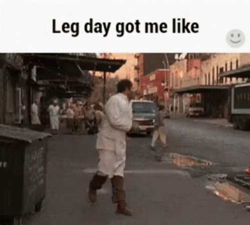 A Man Is Walking Down A Street With The Words Leg Day Got Me Like On The Bottom . GIF