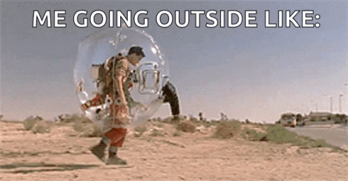 A Man Is Walking In A Bubble On The Side Of A Road . GIF