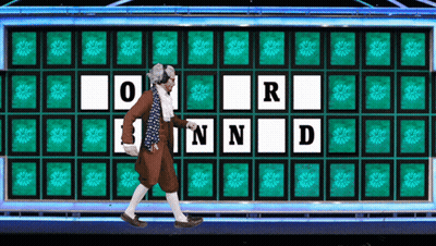 A Man Is Walking In Front Of A Wheel Of Fortune With The Letters O R N And D GIF