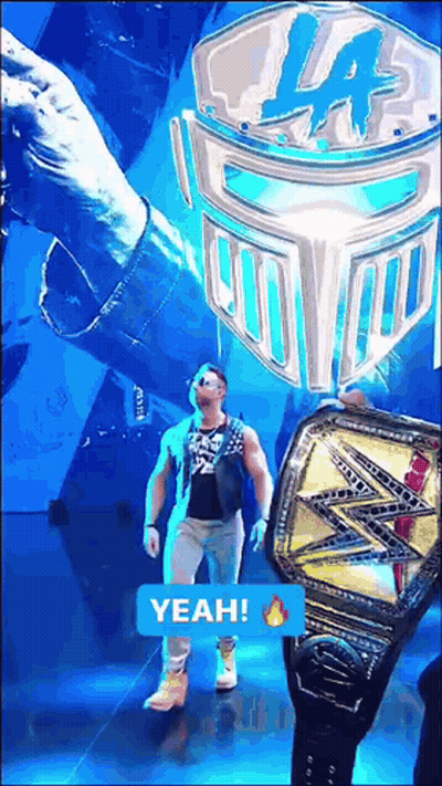 A Man Is Walking On A Stage With A Yeah Sticker On The Bottom GIF