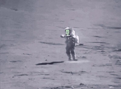 A Man Is Walking On The Moon With A Green Screen On His Helmet . GIF