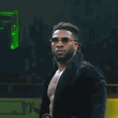 A Man Is Walking Through A Tunnel With Christmas Trees And A Ruler Sign GIF