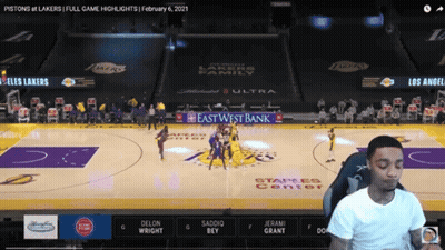 A Man Is Watching A Basketball Game Between The Pistons And Los Angeles Lakers GIF