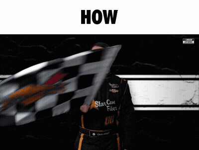 A Man Is Waving A Checkered Flag With The Words How Above Him GIF