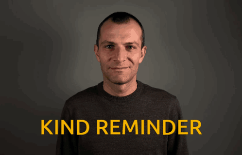 A Man Is Waving His Hand In Front Of A Sign That Says Kind Reminder GIF