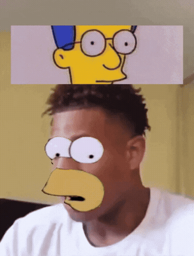 A Man Is Wearing A Bart Simpson Mask On His Face GIF