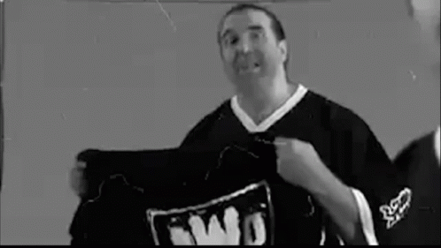 A Man Is Wearing A Black And White Basketball Jersey With The Number 10 On It . GIF