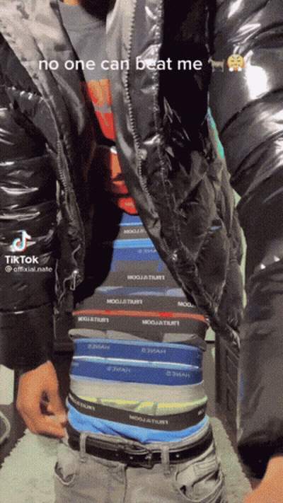 A Man Is Wearing A Black Jacket And Underwear That Says No One Can Beat Me On It GIF