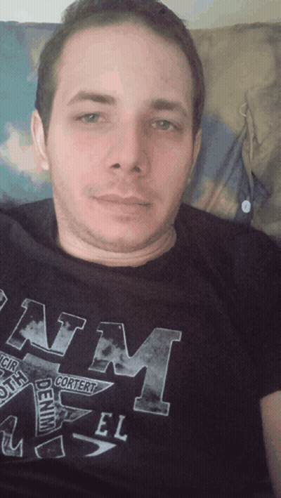 A Man Is Wearing A Black Shirt That Says Denim On It GIF