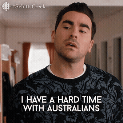 A Man Is Wearing A Black Shirt That Says I Have A Hard Time With Australians GIF