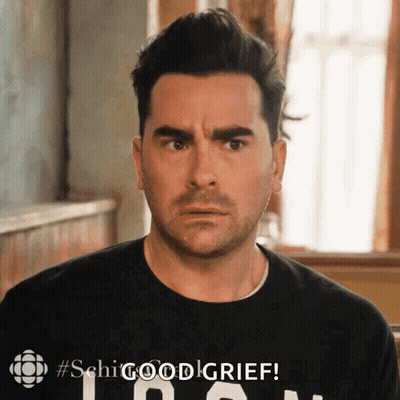 A Man Is Wearing A Black Shirt That Says ' Shg Good Grief ' On It GIF