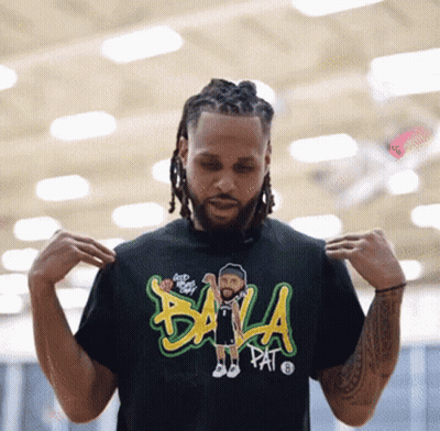 A Man Is Wearing A Black T-Shirt That Says Bala Pat On It GIF