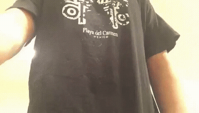 A Man Is Wearing A Black T-Shirt That Says Playa Del Carmen Mexico On It . GIF