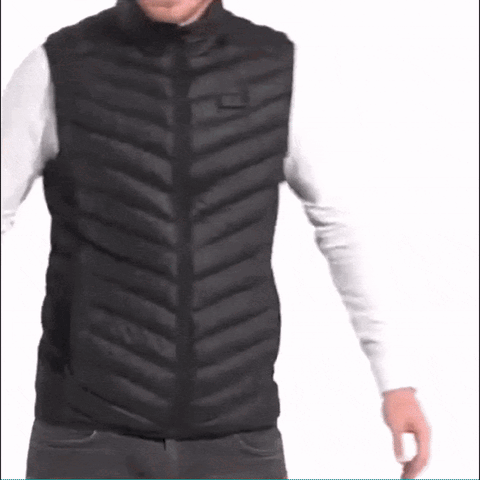 A Man Is Wearing A Black Vest And A White Shirt . GIF