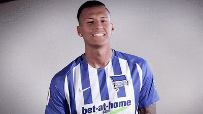 A Man Is Wearing A Blue And White Striped Shirt That Says Bet-At-Home GIF