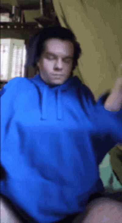 A Man Is Wearing A Blue Hoodie And Headphones GIF
