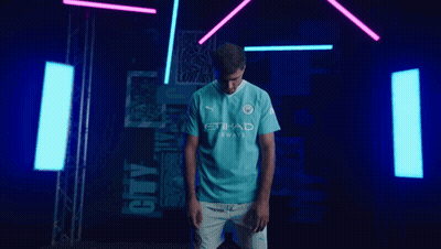 A Man Is Wearing A Blue Shirt That Says Etihad Airways GIF