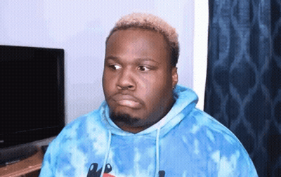 A Man Is Wearing A Blue Tie Dye Hoodie And Making A Funny Face . GIF