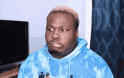 A Man Is Wearing A Blue Tie Dye Hoodie And Making A Funny Face . GIF