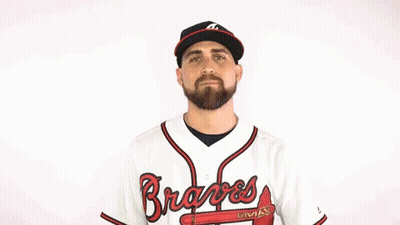 A Man Is Wearing A Braves Jersey And A Hat GIF