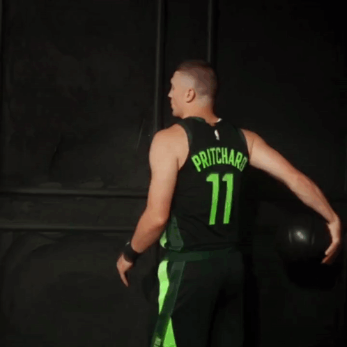 A Man Is Wearing A Celtics Jersey With The Number 11 On It GIF