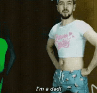 A Man Is Wearing A Crop Top And Shorts And Says I 'M A Dad . GIF