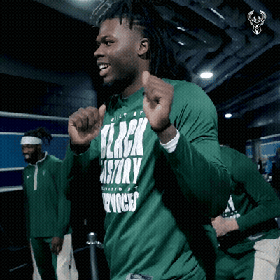 A Man Is Wearing A Green Shirt That Says Black History GIF