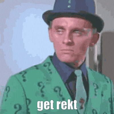 A Man Is Wearing A Green Suit With Question Marks On It GIF