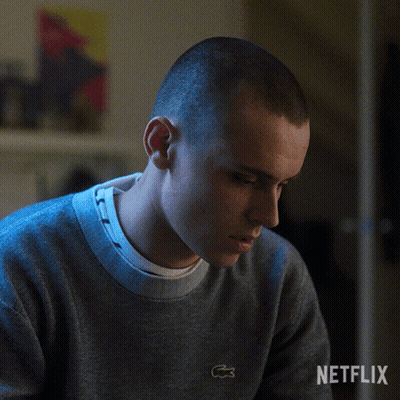 A Man Is Wearing A Grey Sweater With A Lacoste Logo On The Front GIF