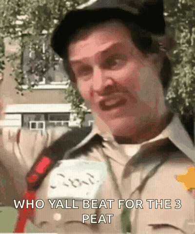 A Man Is Wearing A Hat And A Name Tag That Says " Who Yall Beat For The 3 Peat " . GIF