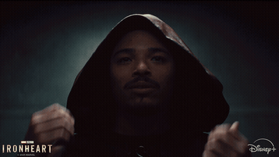 A Man Is Wearing A Hooded Jacket With The Words Ironheart On The Bottom GIF