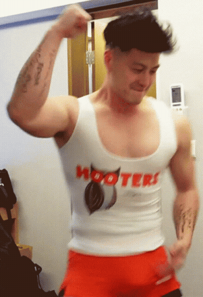 A Man Is Wearing A Hooters Tank Top GIF