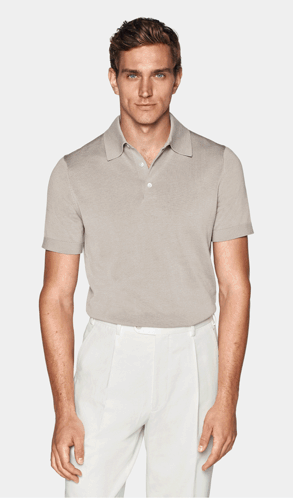 A Man Is Wearing A Light Blue Polo Shirt And White Pants GIF