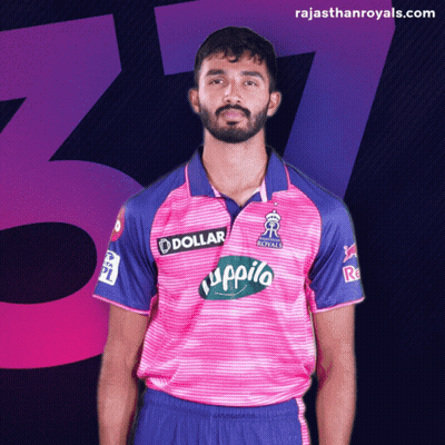 A Man Is Wearing A Pink And Blue Shirt With A Dollar Logo On It GIF