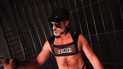 A Man Is Wearing A Police Vest And Sunglasses GIF