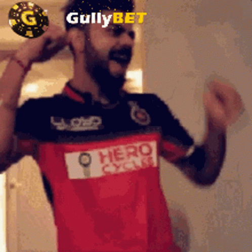 A Man Is Wearing A Red And Black Shirt With The Word Hero On It GIF