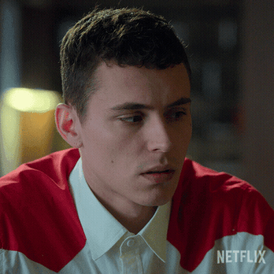 A Man Is Wearing A Red And White Shirt With Netflix Written On The Sleeve GIF