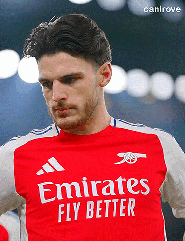 A Man Is Wearing A Red Emirates Fly Better Jersey GIF