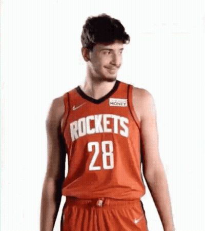 A Man Is Wearing A Red Rockets Jersey And Shorts . GIF