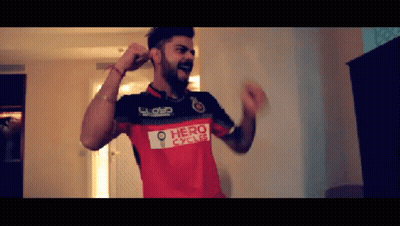 A Man Is Wearing A Red Shirt That Says Hero Cycles GIF