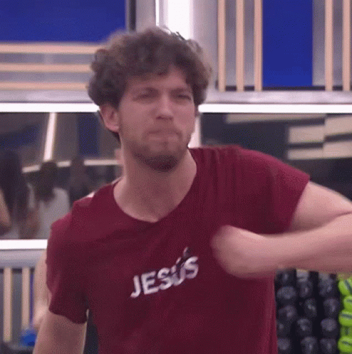 A Man Is Wearing A Red Shirt That Says Jesus GIF