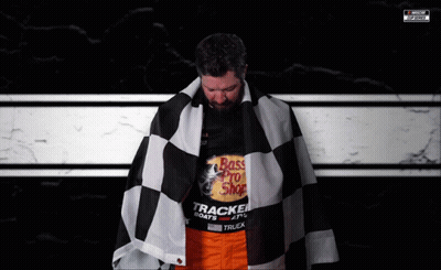A Man Is Wearing A Shirt That Says Bass Pro Shop On It GIF