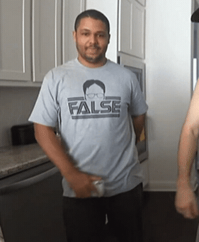 A Man Is Wearing A Shirt That Says False On It GIF
