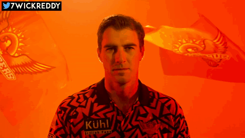 A Man Is Wearing A Shirt That Says " Kuhl " On It GIF