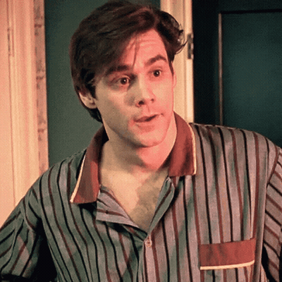 A Man Is Wearing A Striped Shirt And Looking At The Camera GIF