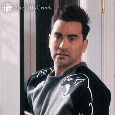 A Man Is Wearing A Sweater With A Panther On It And The Word Schitts Creek Is On The Bottom GIF
